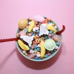 A bowl of colorful cereal, candies, and multi-colored marshmallows