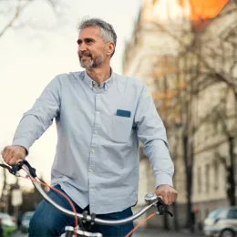 man on a bike riding through a city