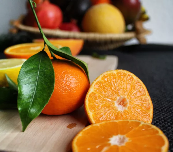 tangerines in front of a fruit bowl